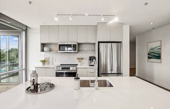 a kitchen with white counter tops and a sink