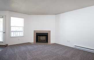 a living room with a fireplace and white walls