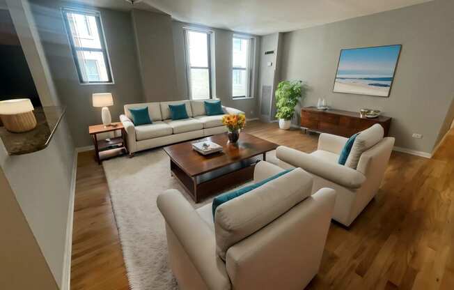 a living room with white couches and a coffee table