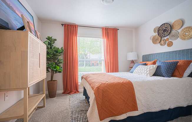 a bedroom with a bed and a dresser and a window