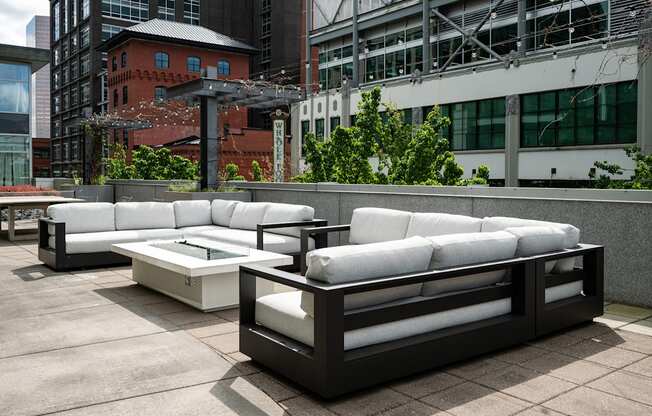 A white couch and table set on a patio.