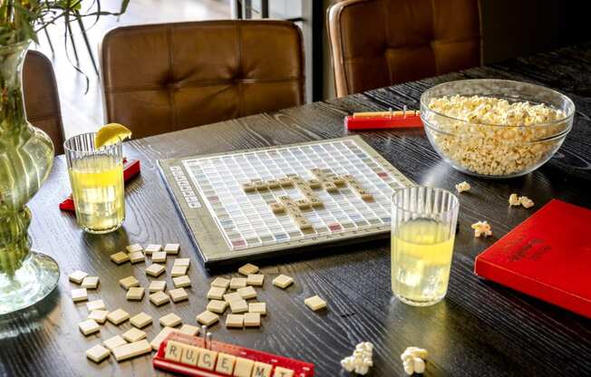 a table with a board game and a bowl of popcorn on it