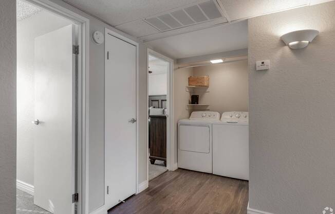 A kitchen with white appliances and cabinets is shown.