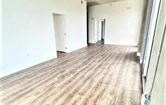 a empty living room with a hard wood floor