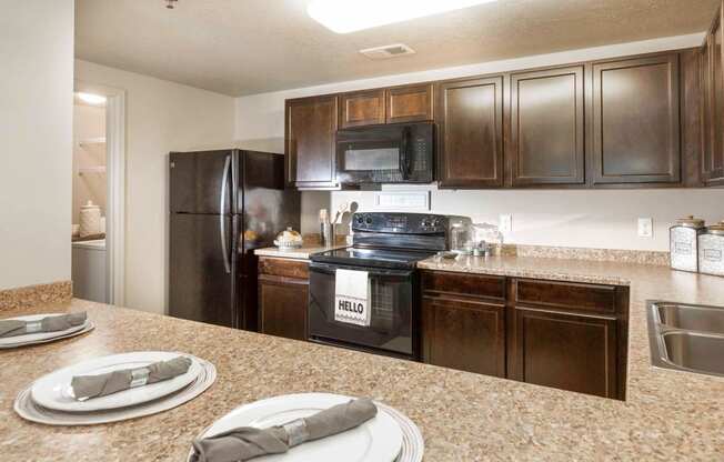 a kitchen with wooden cabinets and black appliances