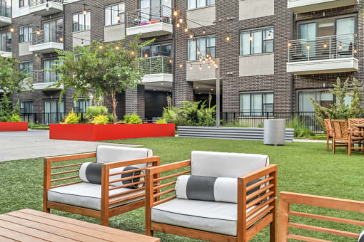 our apartments showcase a naturally grassed area with a fire pit