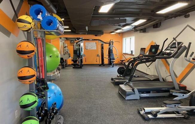 a gym with a lot of exercise equipment in it at Troy Place Apartments - Troy, MI, Troy, Michigan