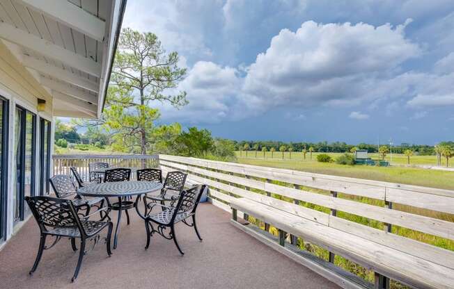 Outdoor Seating with Green Views at River Crossing Apartments, Thunderbolt, GA