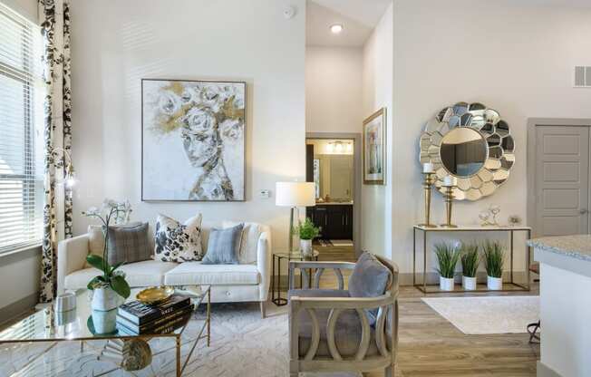 a living room with a couch and chairs and a table