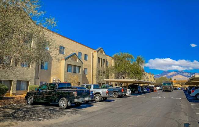 a parking lot with cars parked in front of a building