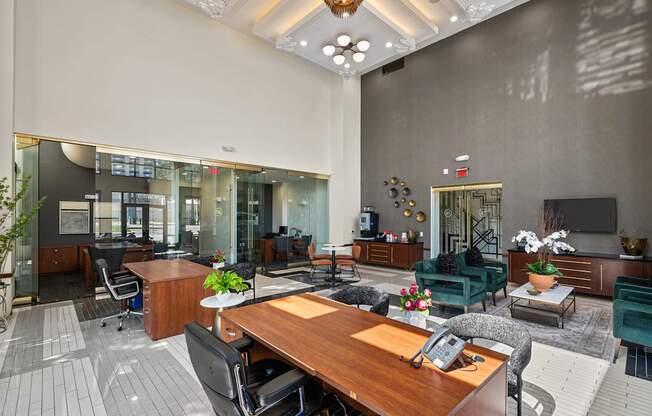 A modern office space with a reception desk and multiple seating areas.