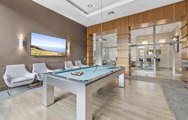a games room with a pool table and chairs at Harbor Pointe, Bayonne, NJ, 07002