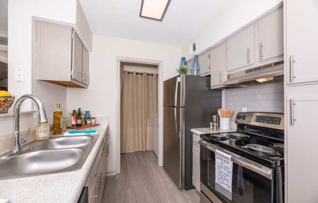 a kitchen with stainless steel appliances and white cabinets