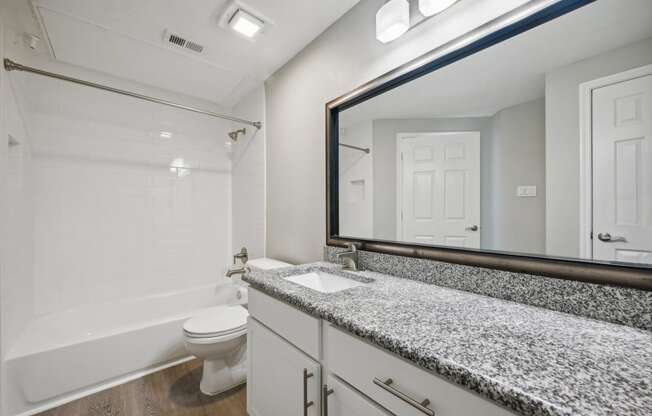 a bathroom with granite counters