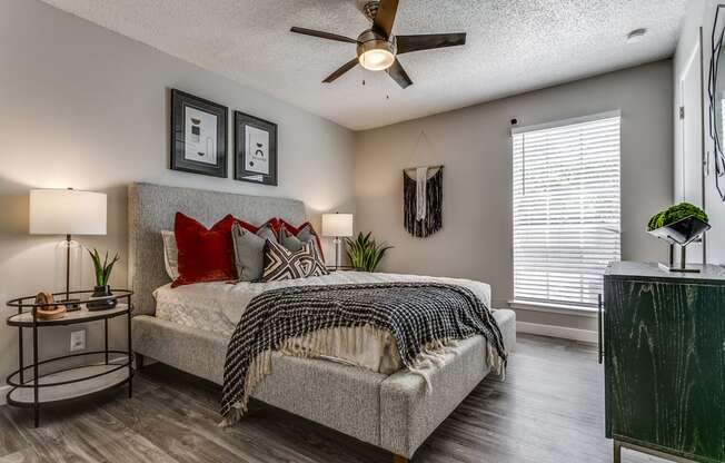 a bedroom with a bed and a ceiling fan