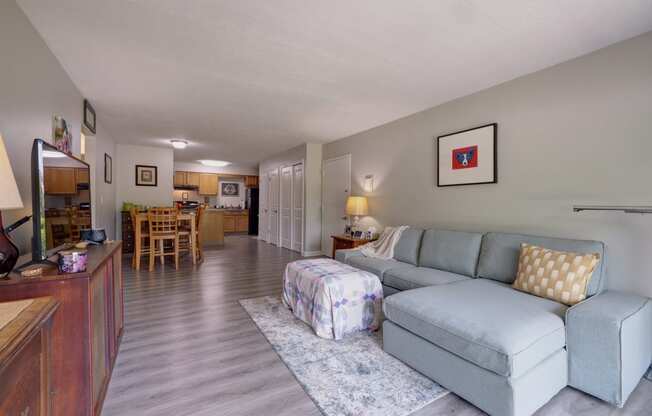 a living room and dining room with a couch and a table