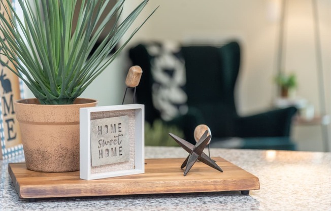 a wooden tray with a starfish and a picture on it on a counter next to a at The Bend Arbordale, Virginia, 23188