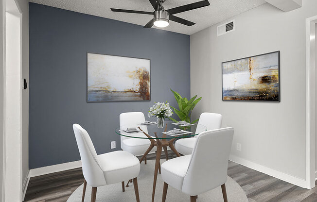 Hardwood floored dining area with celling fan.