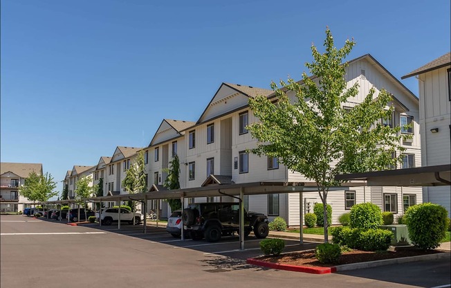 A row of houses with a tree in front of them at Riverplace Apartment Homes, Oregon, 97351
