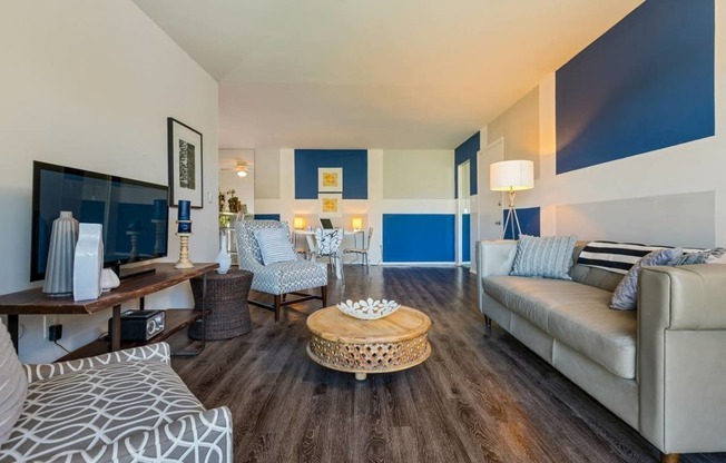 a living room with blue and white walls and a couch at Village Club of Royal Oak, Michigan