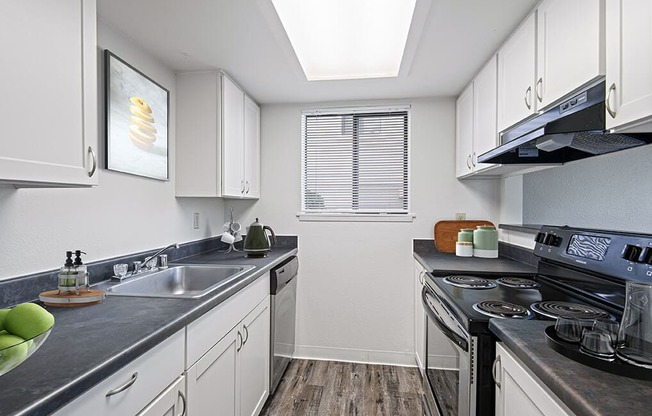 a kitchen with stainless steel appliances and white cabinets