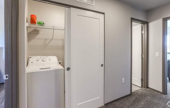 Laundry room with washer and dryer, and built-in cabinets.