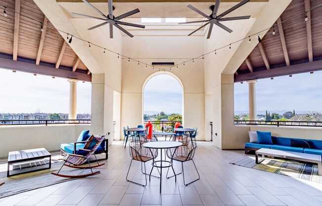 a large patio with chairs and tables and a view
