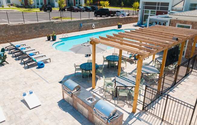 an overhead view of a resort style swimming pool with a jacuzzi