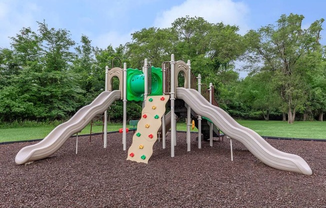 a playground with slides and a rock wall