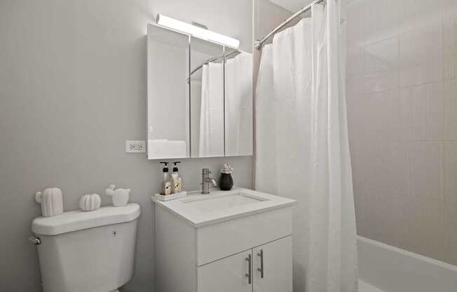 a bathroom with a sink toilet and a shower