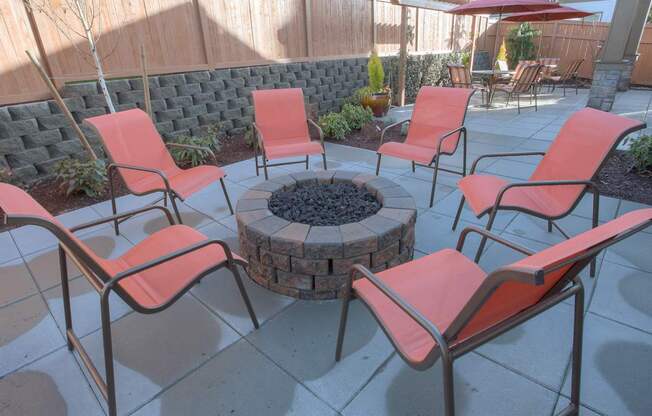 A patio with a fire pit and chairs. at Mill Creek Meadows Apartments, Mill Creek, WA, 98012