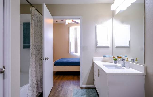 luxury bathroom with modern white cabinetry at Roosevelt Square apartments