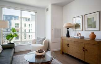 a living room with a large window and a coffee table at Slabtown Square Apartments, Portland , Oregon