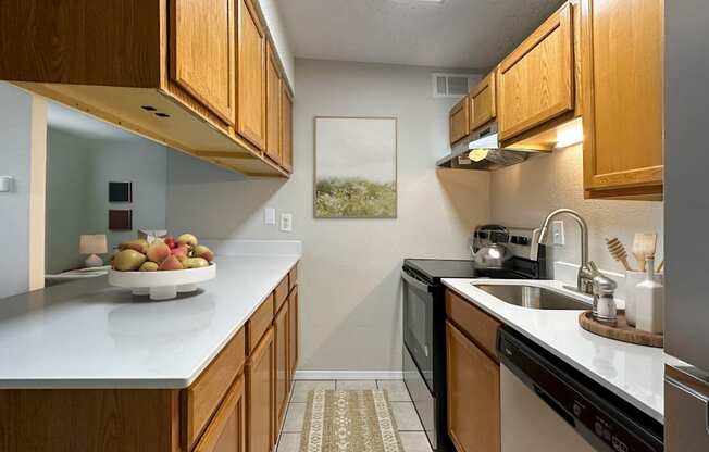 Kitchen with dark appliances and granite-style counters near Gateway Park in Aurora.