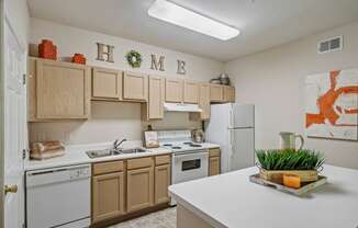 a kitchen with white appliances and wooden cabinets