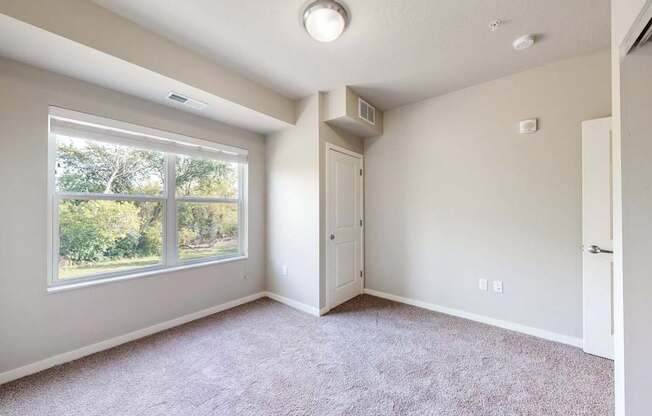 A room with a window and a door.