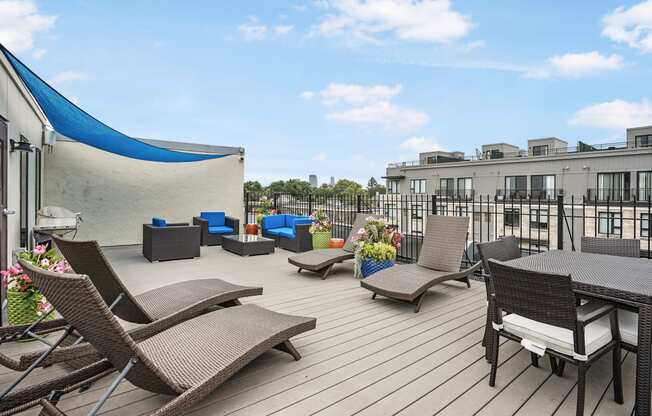 the terrace of a condo with a table and chairs