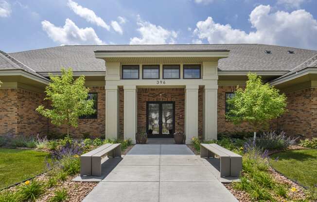 a building with a walkway and benches in front of it