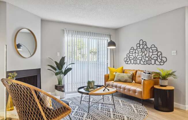 a living room with a yellow couch and a black and white rug