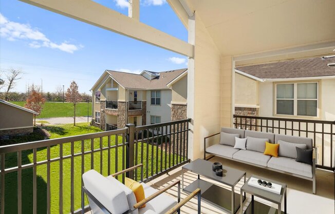 a patio with a couch and a table on a balcony