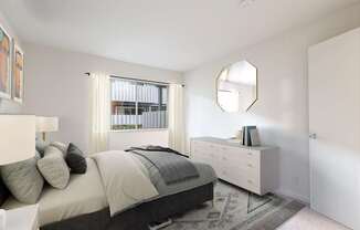 A bedroom with a bed, dresser, and mirror.