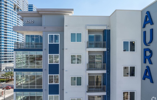 A modern building with the word AURA on the side.