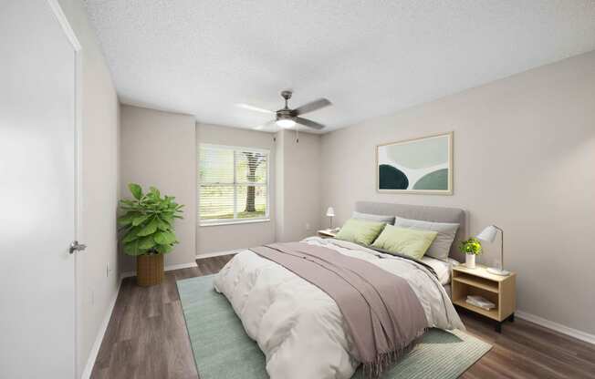 a bedroom with a bed and a ceiling fan