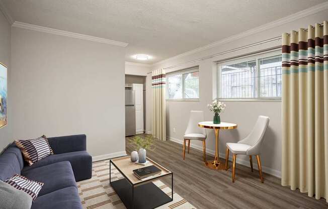 A living room with a blue couch and a coffee table.