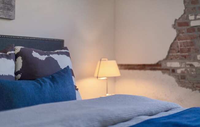 a bedroom with a bed and a lamp at The 22 Apartments, St. Louis