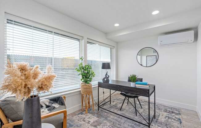 an office with a large window and a desk with a chair