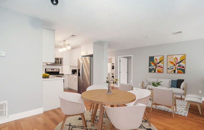 a living room and dining room with a table and chairs