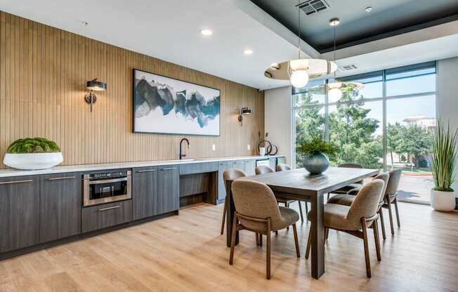 a kitchen and dining room with a table and chairs