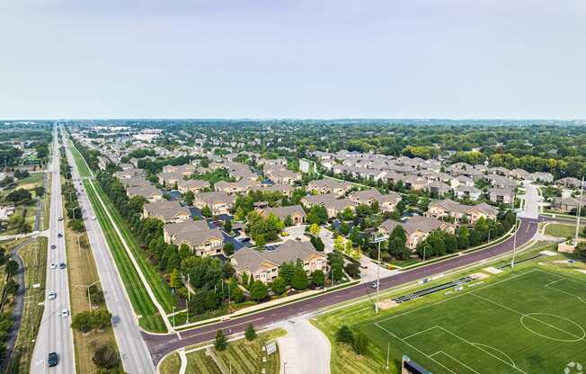 an aerial view of a neighborhood of houses and a highway at Sovereign at Overland Park, Overland Park  