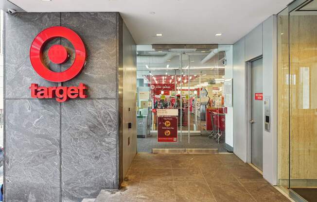 The Target logo is displayed on a grey wall above a set of double doors.
